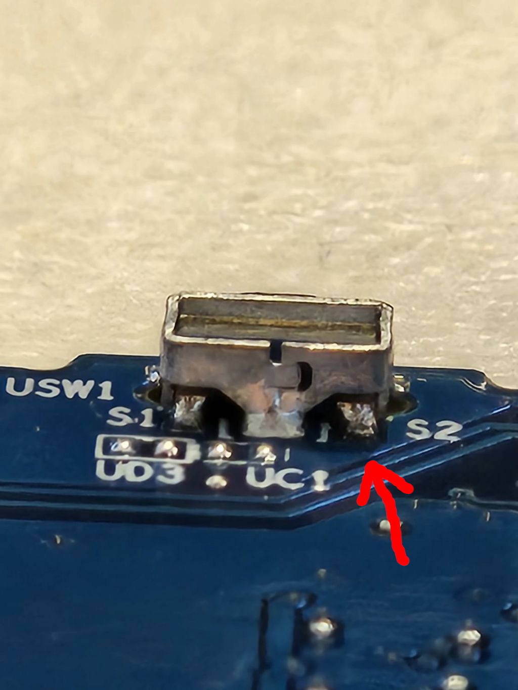 Photo of power button on laptop's PCB